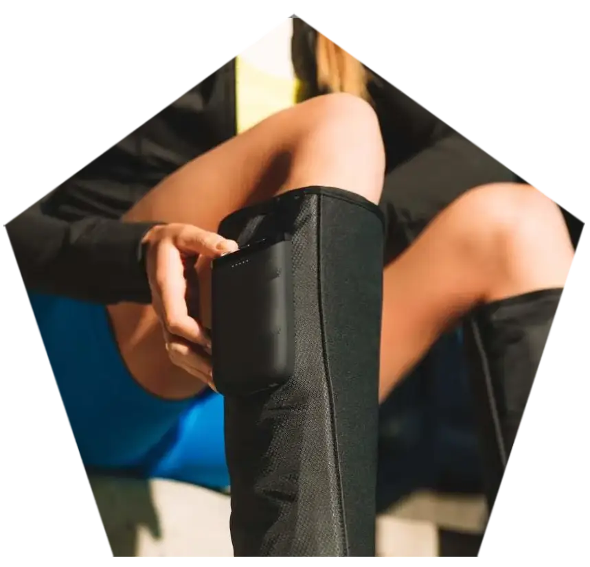 A patient using a specialized leg compression device for recovery.