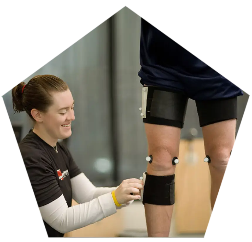 A specialist applying sensors for a professional gait analysis session.